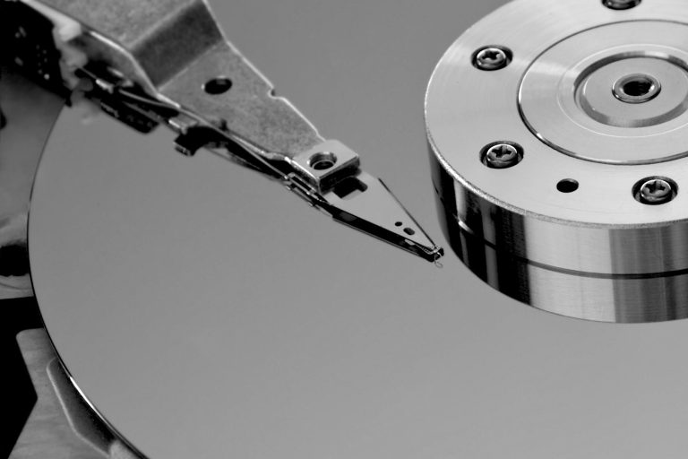 Damaged hard drive being restored with data recovery tools, representing data recovery services and the retrieval of lost or corrupted data.