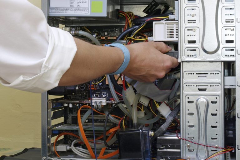 Technician repairing a computer, symbolizing computer repair services and troubleshooting expertise.