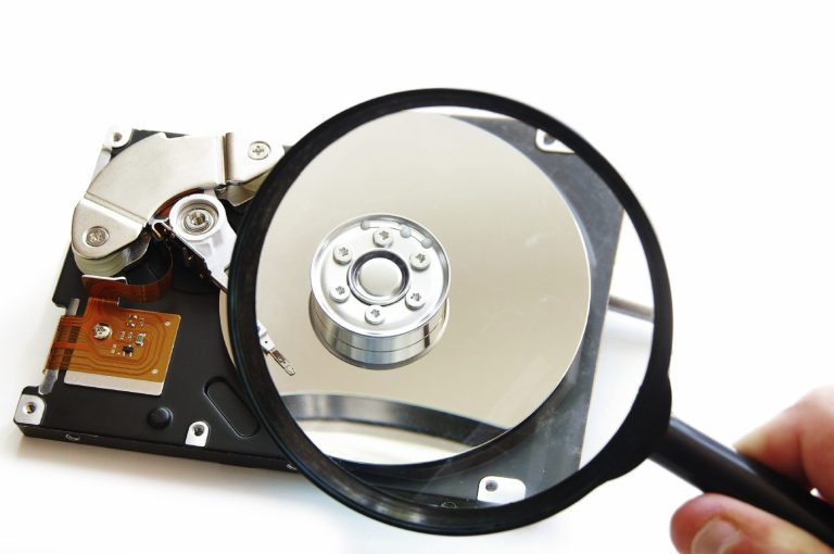 hard drive bein examine with a magnifying glass 