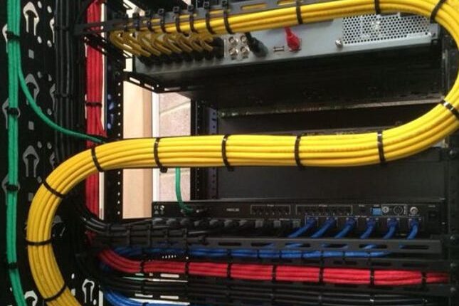Structured cabling setup with cables neatly organized, illustrating data and voice cabling infrastructure.